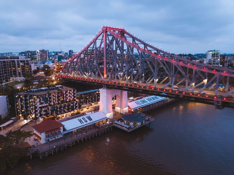 Aerial view of Story Bridge over a river with a ferry terminal at Howard Smith Wharves near Sofitel Brisbane Central