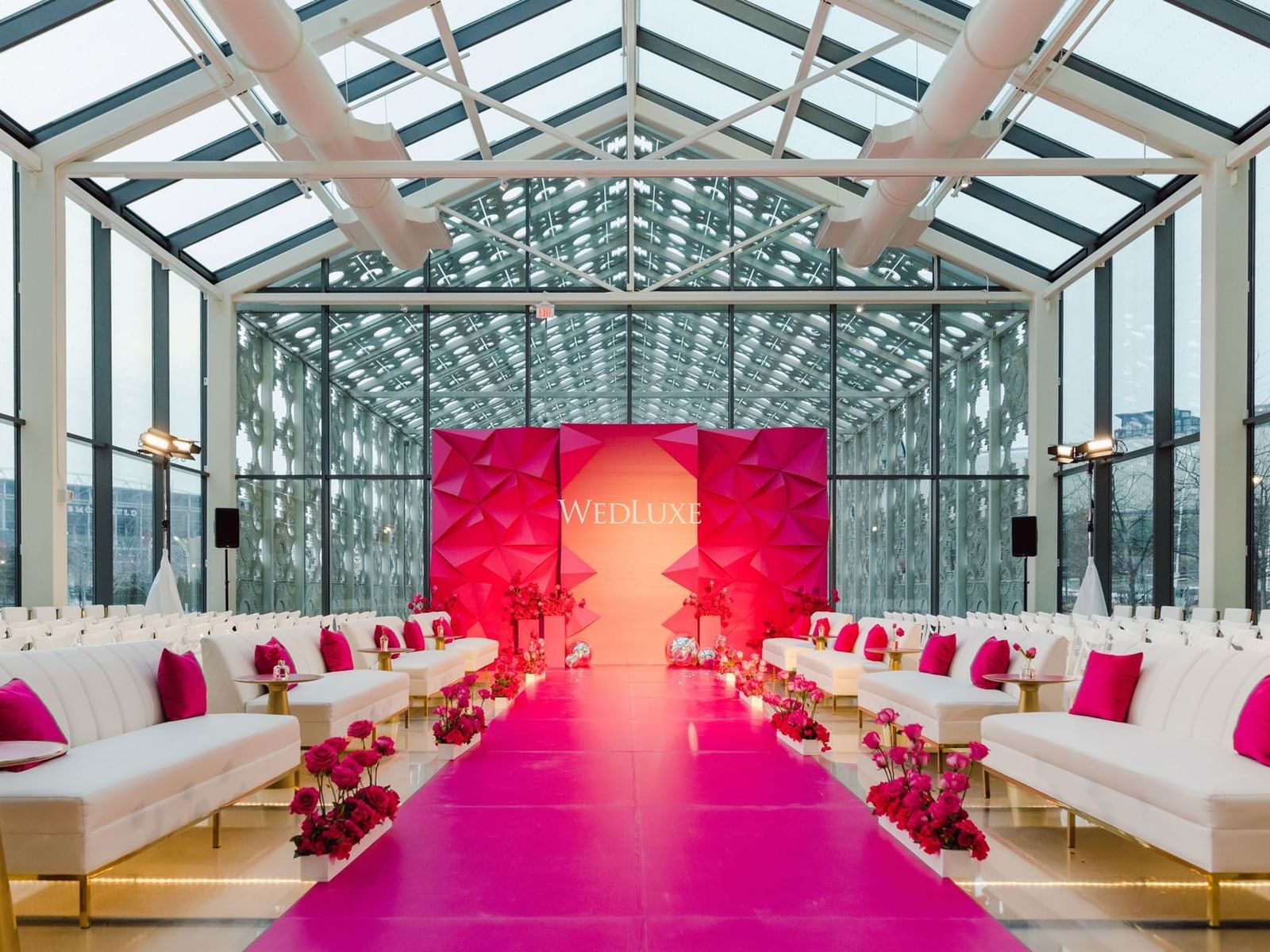 New Fort Hall with white sofas, pink carpet, and geometric stage backdrop at Hotel X Toronto