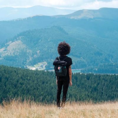 Lady enjoying the view on top of mountain near Originals Hotels