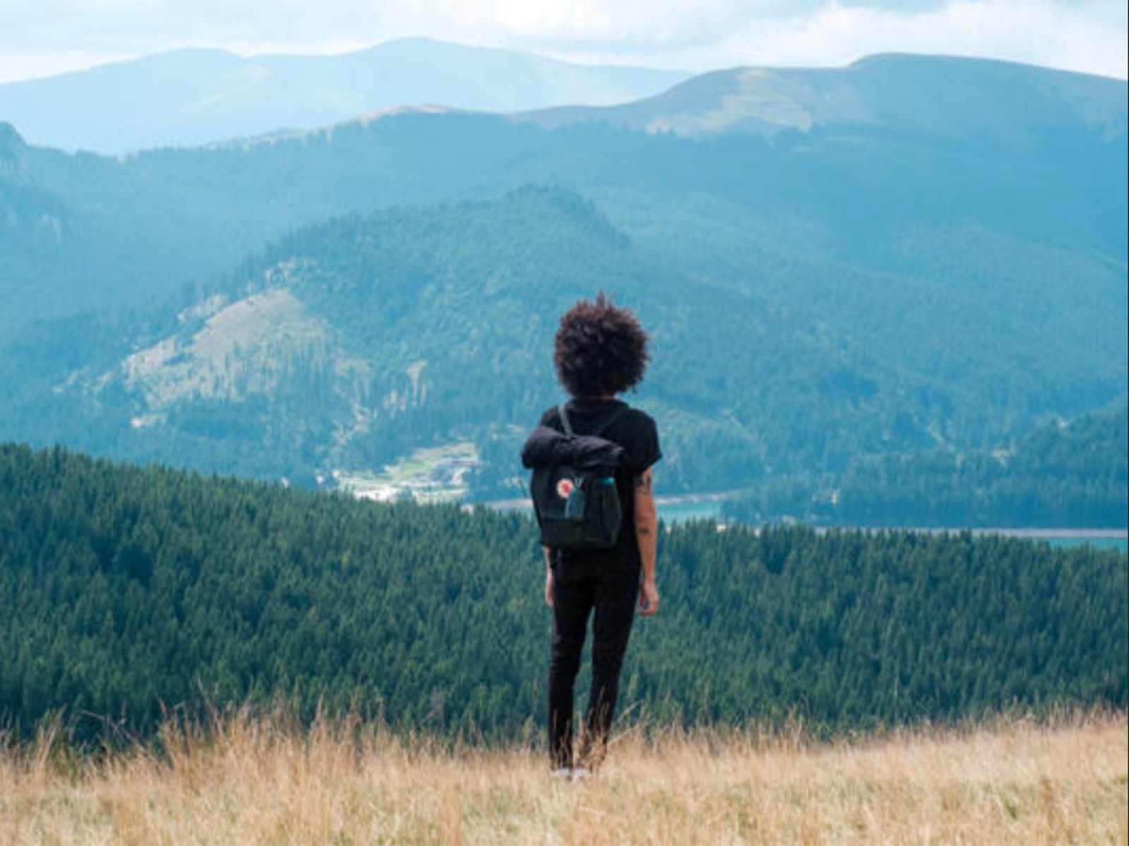 Lady enjoying the view on top of mountain near Originals Hotels