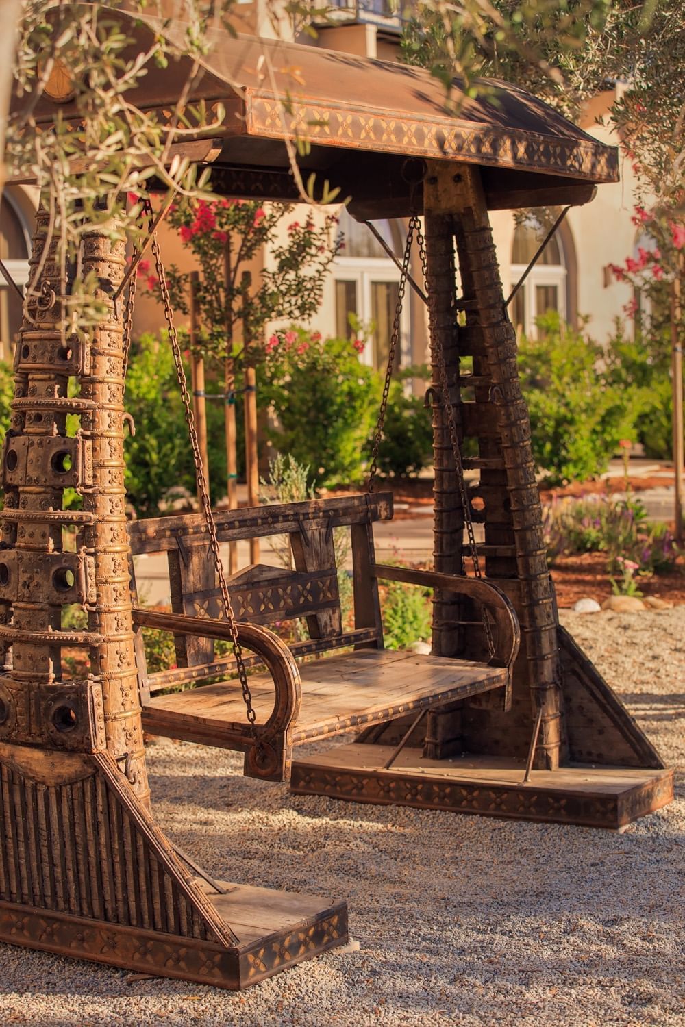 Lorem ipsum An inviting wooden swing among the exterior landscape of the res