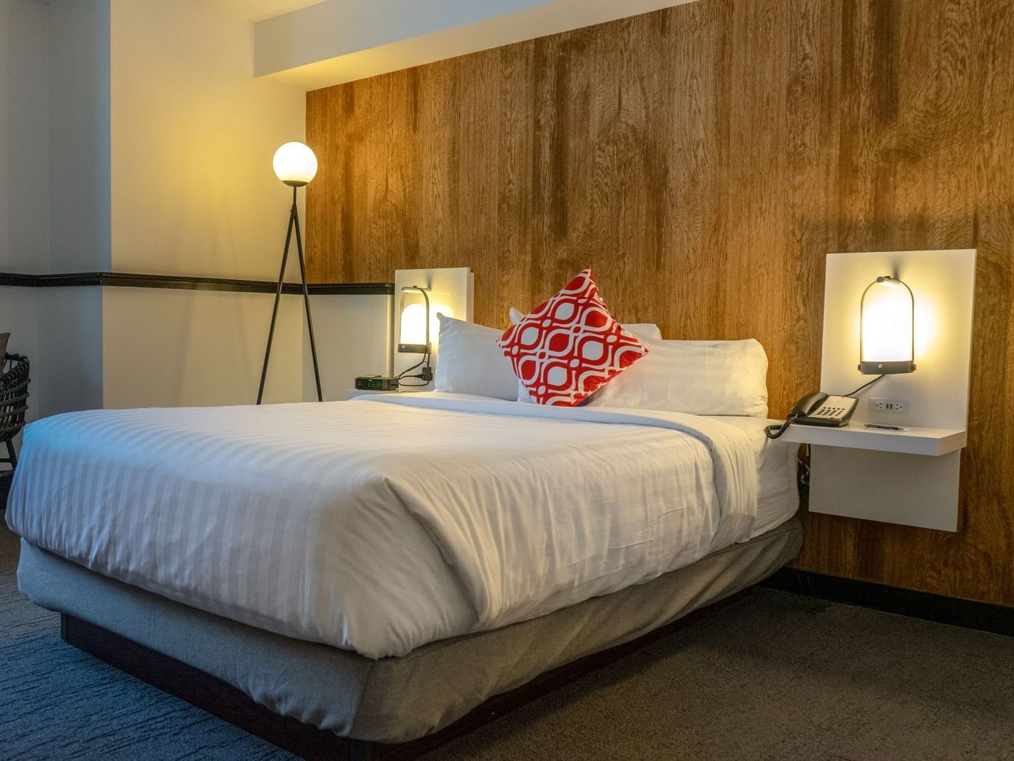 Bed in hotel room with wooden walls
