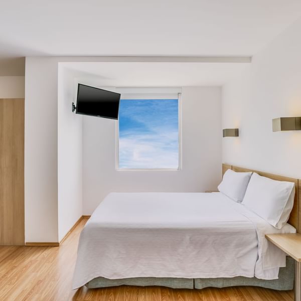 Cozy bed, nightstand & TV in Accessible Room at One Hotels
