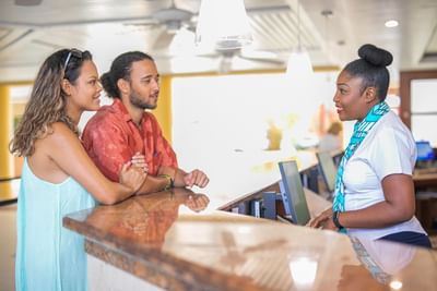A couple talking with a receptionist at Holiday Inn Montego Bay