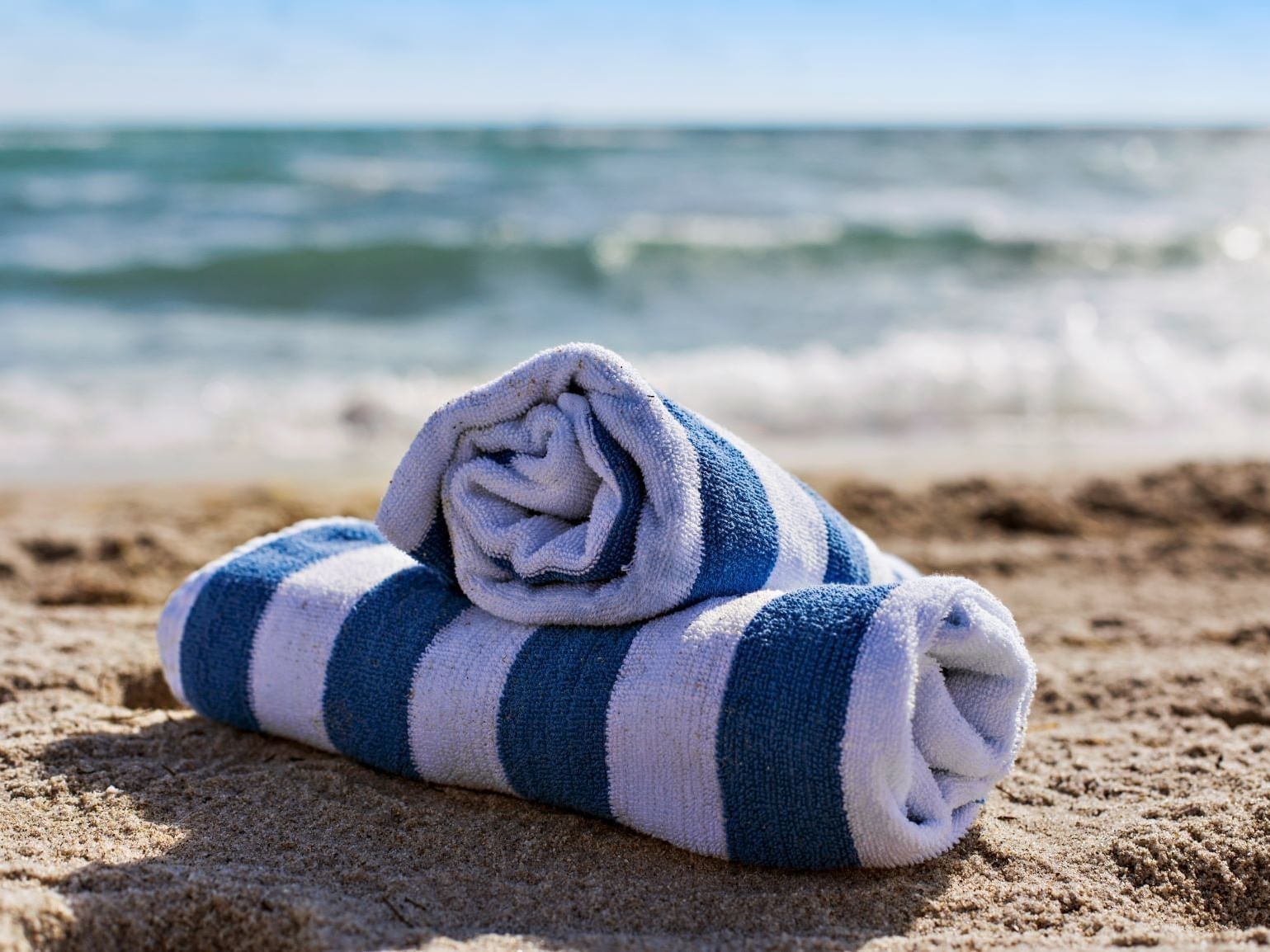 Closeup of towel rolls by the beach at DOT Hotels