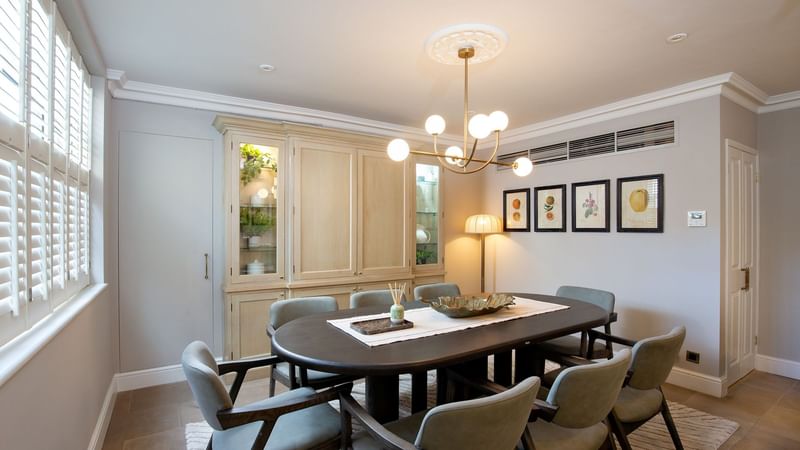 Dining area with table and chairs in Three Bedroom Penthouse at The Capital Hotel, Apartments & Townhouse - London.