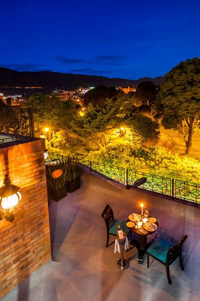 A night view of the cityscape from a terrace at Le Manoir Bogotá Hotel