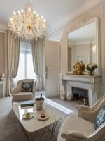 Elegant living room of the Prestige Suite with Rue de la Paix View at Hôtel Westminster Paris.