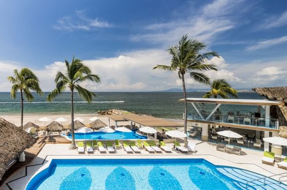 a hotel pool right on the beach