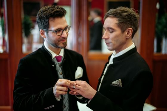 A wedding couple exchanging rings at Schloss Hotel Pichlarn