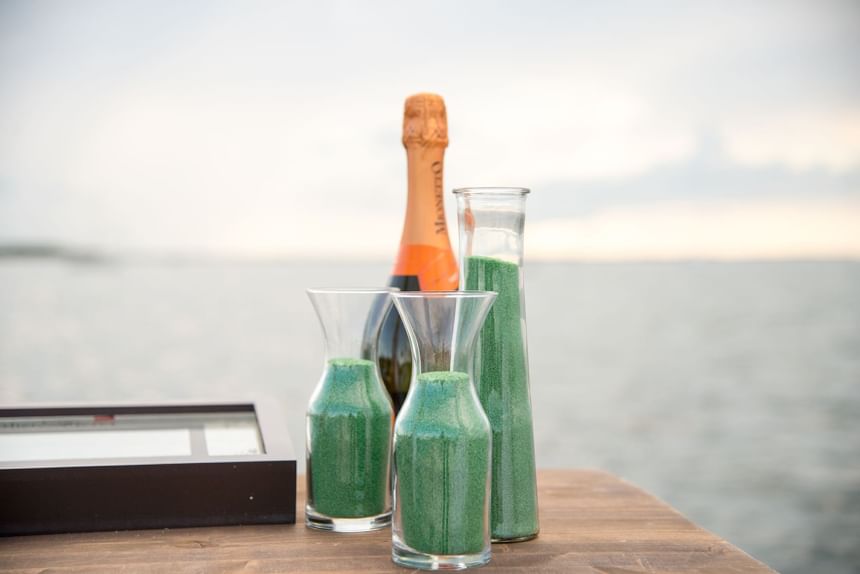 Bottles of sand for ceremony & champagne bottle on table at Bayside Inn Key Largo