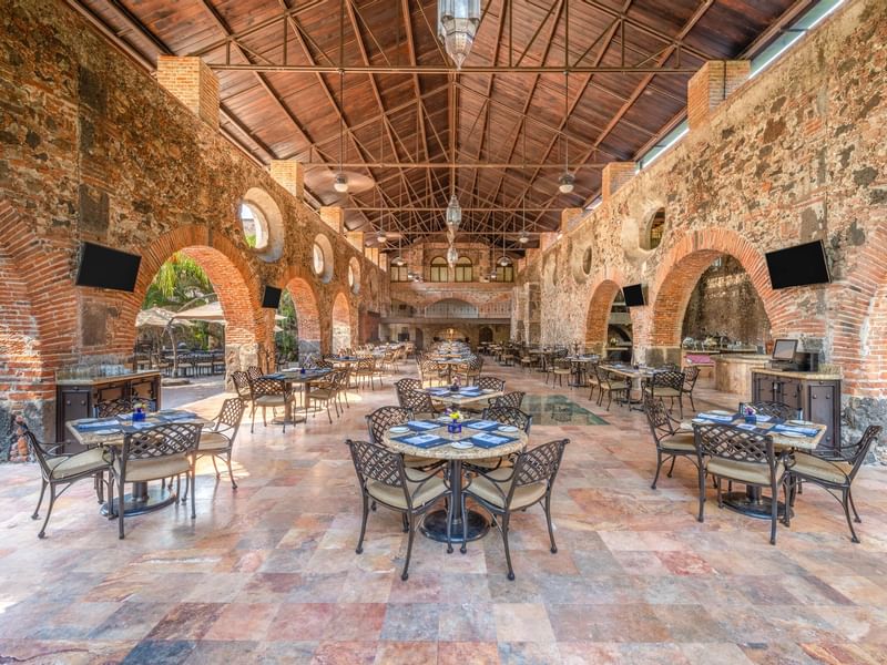 Dining table arrangement in dining hall at Fiesta Americana