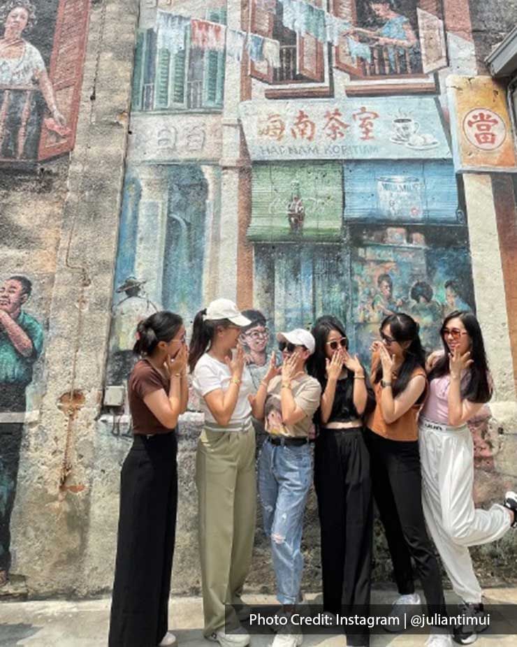 Group of girls posing by wall art in Kwai Chai Hong, a famous attraction near Imperial Lexis Kuala Lumpur