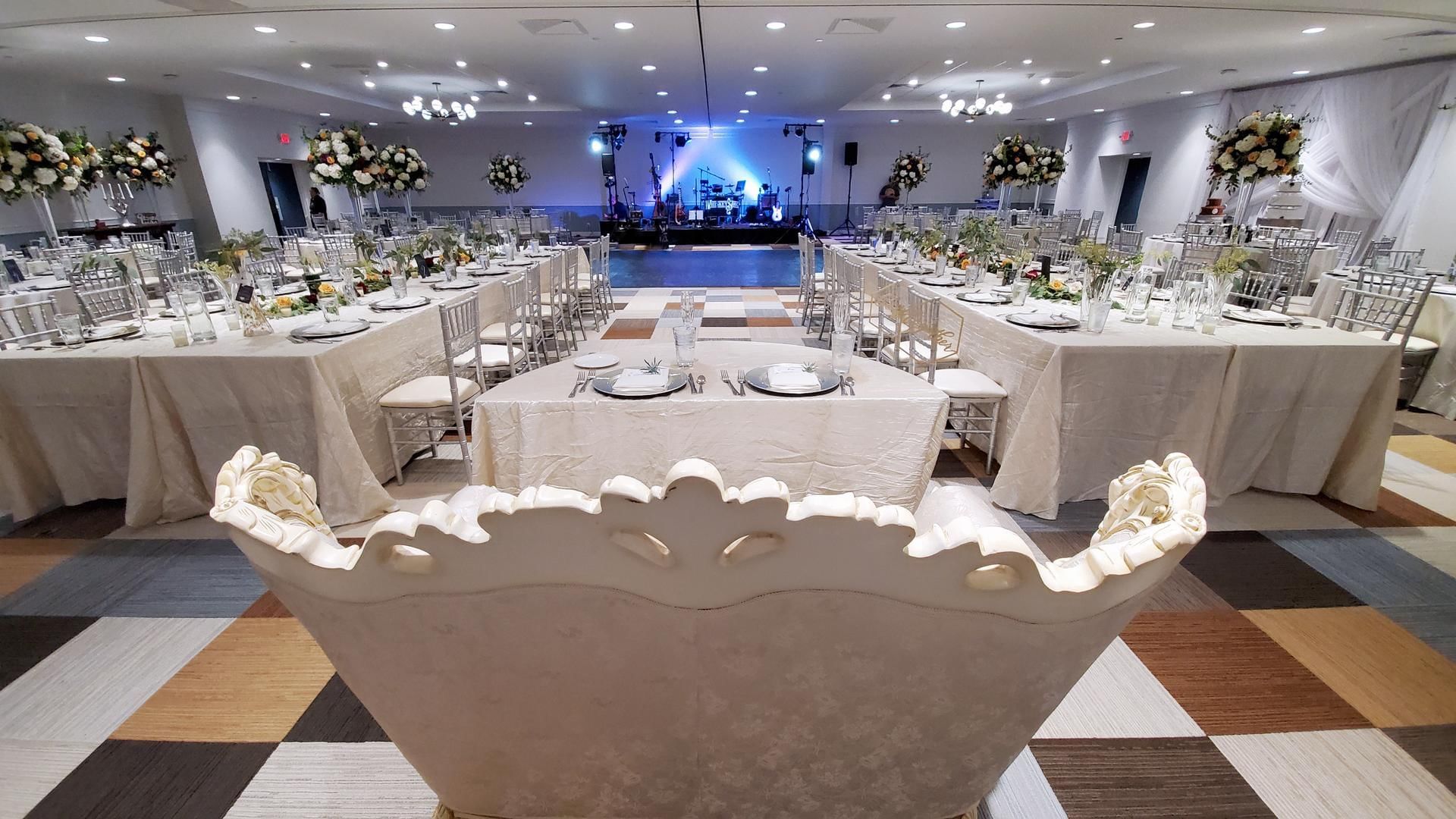 Long wedding table setup in The Barrymore Hotel banquet hall, with elegant decor and floral centerpieces