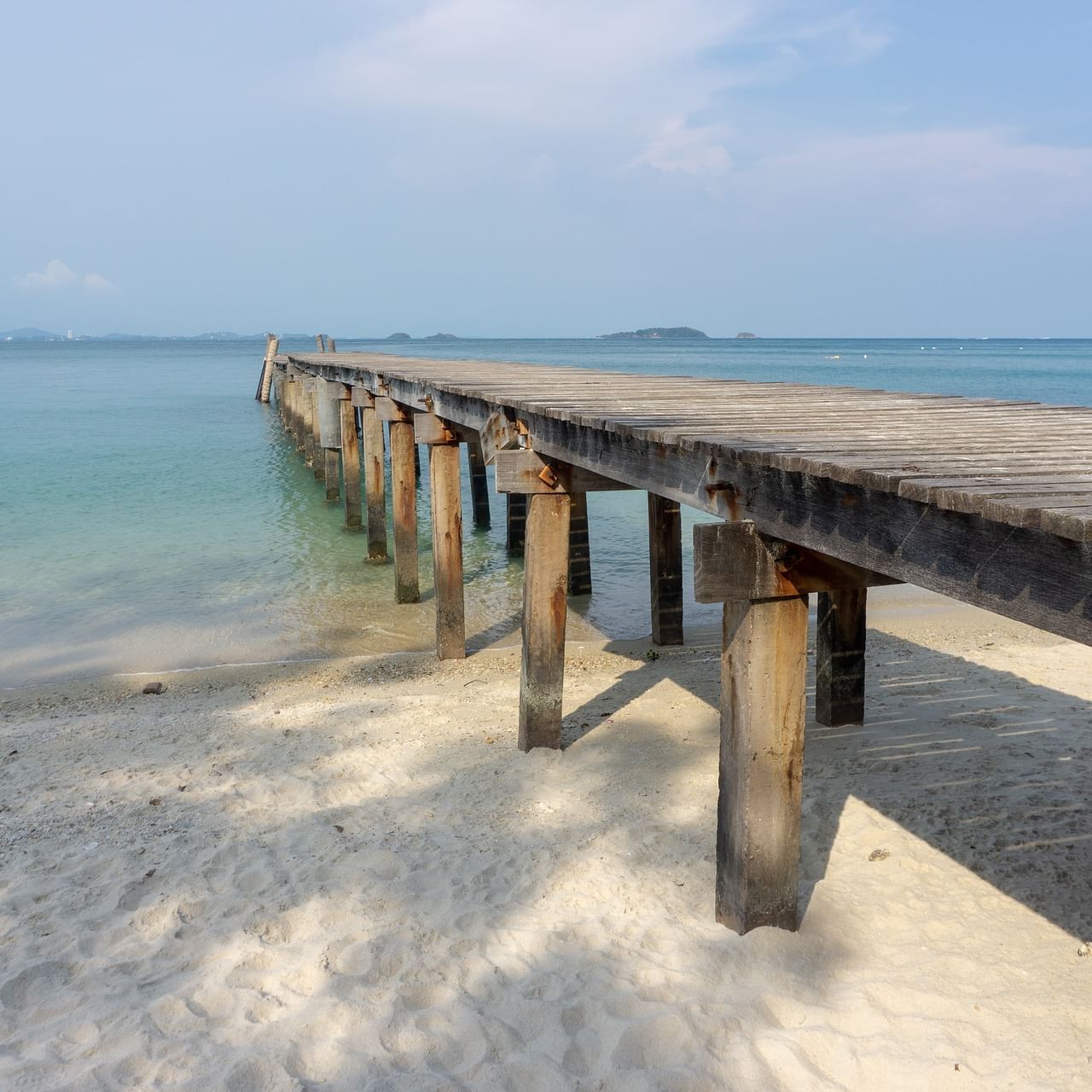 Wooden boardwalk dock to the sea near Eastin Resort Rayong
