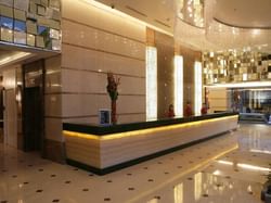 3 receptionists at the reception desk in St Giles Makati Hotel