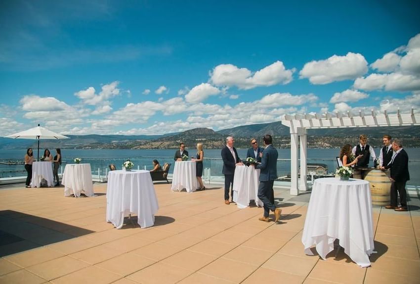 Outdoor cocktail tables with lake view at Hotel Eldorado