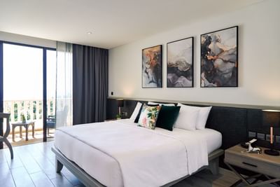 King bed with balcony of a bedroom at Paradox Hotels