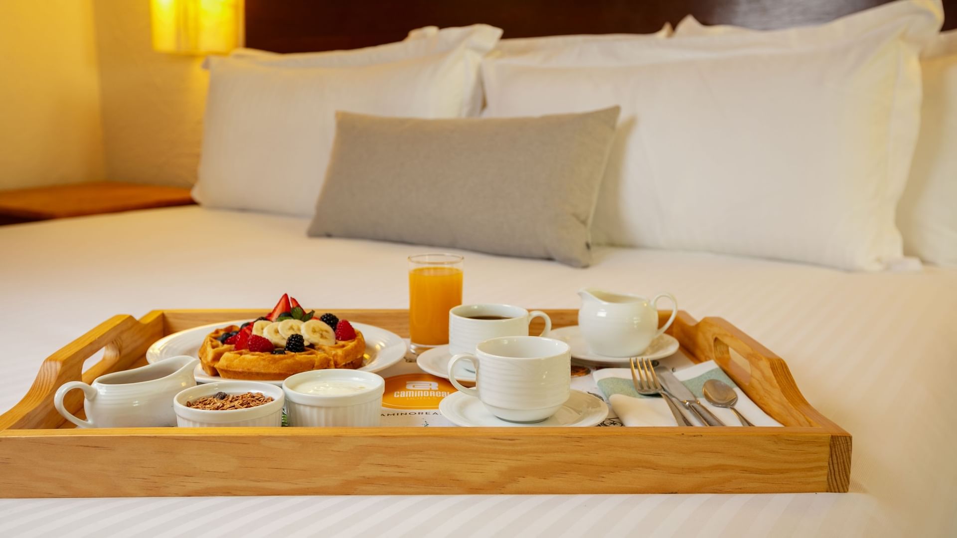 Tray with breakfast on a bed in the King Ambassadors Suite at Camino Real Guadalajara, Zapopan