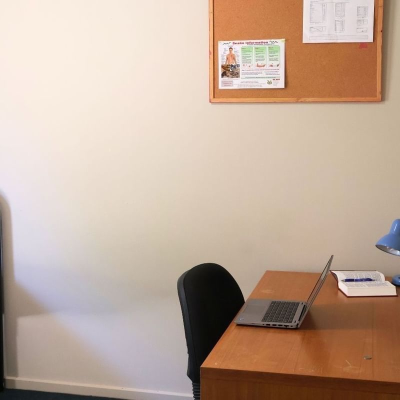 Bedroom with bed, desk, and laptop at La Trobe University - Villas.