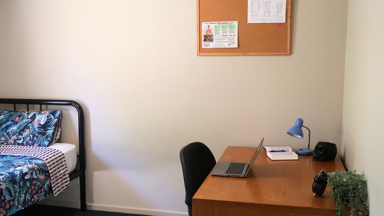 Bedroom with bed, desk, and laptop at La Trobe University - Villas.