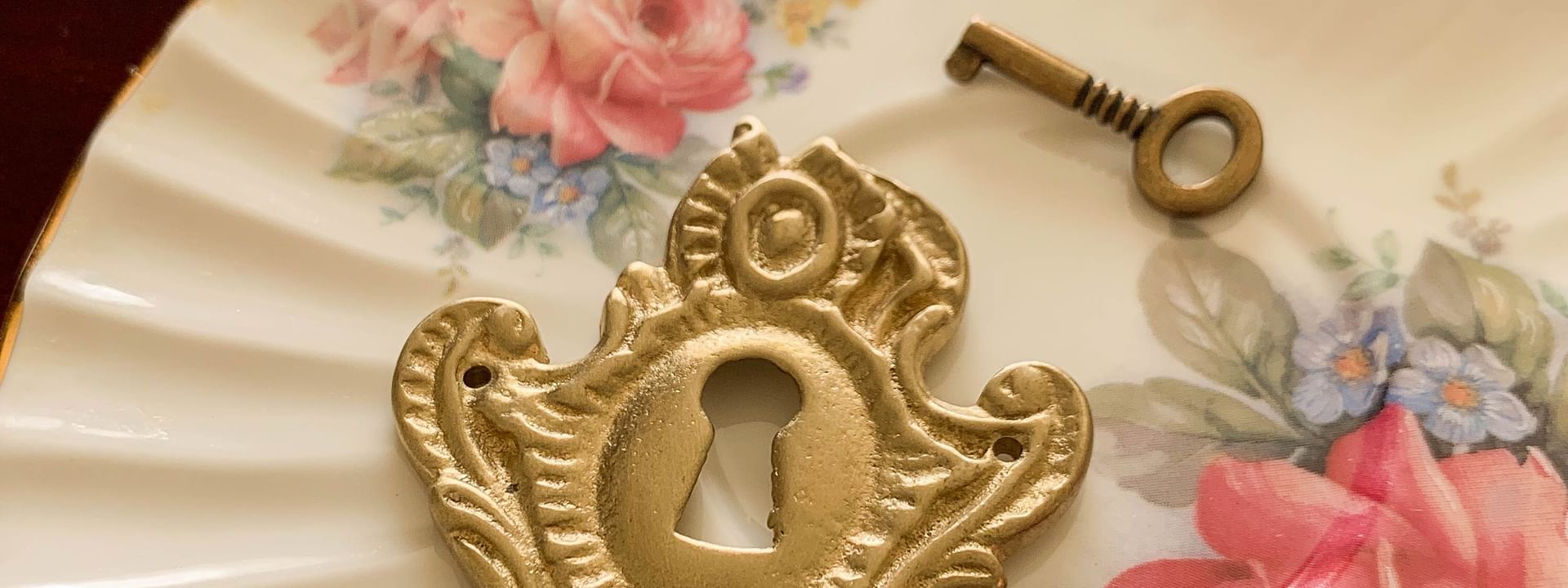 Decorative lock and key on a flowery plate