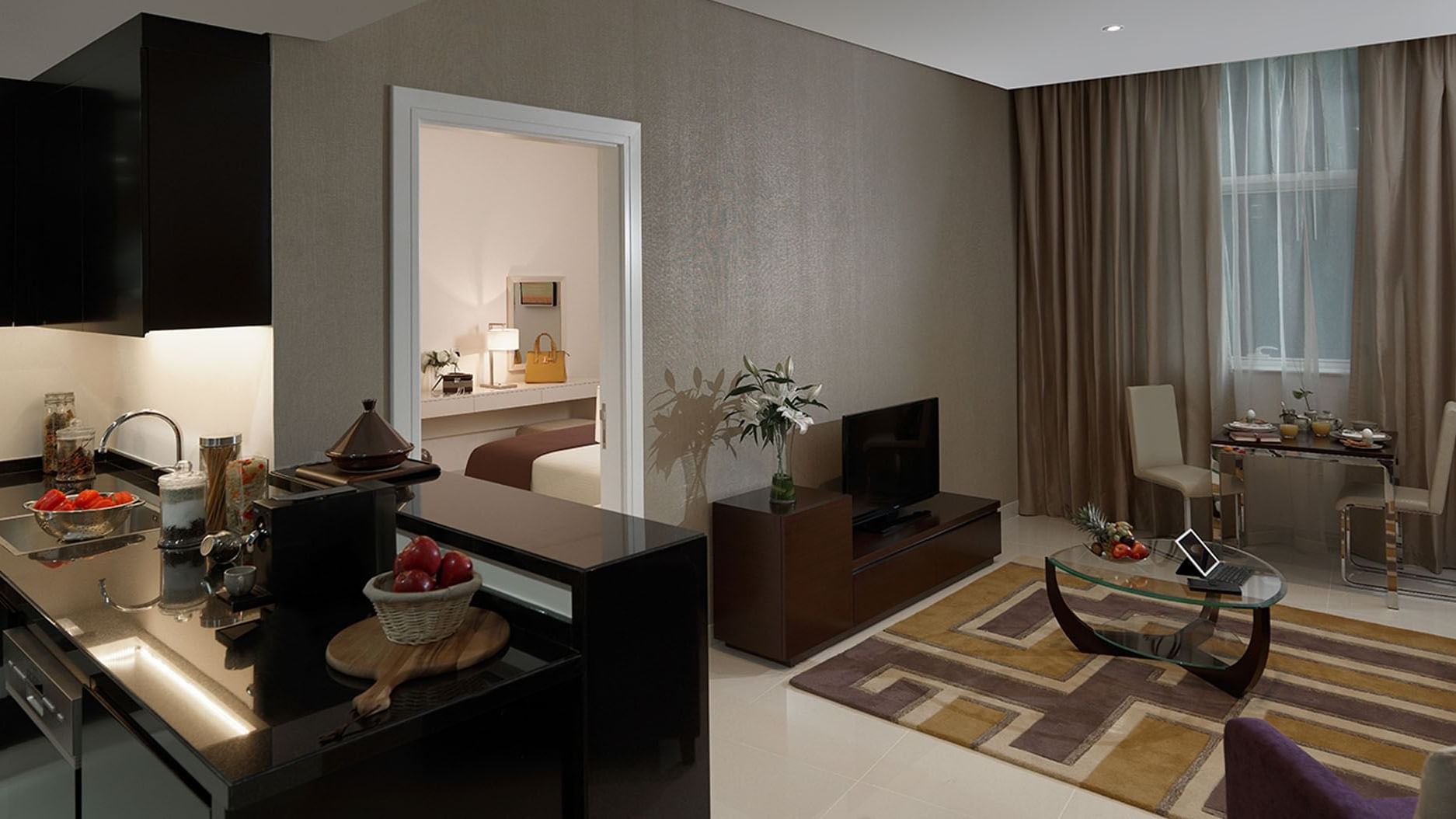 Kitchen & living area featuring modern furniture in Deluxe Room at DAMAC Maison Cour Jardin