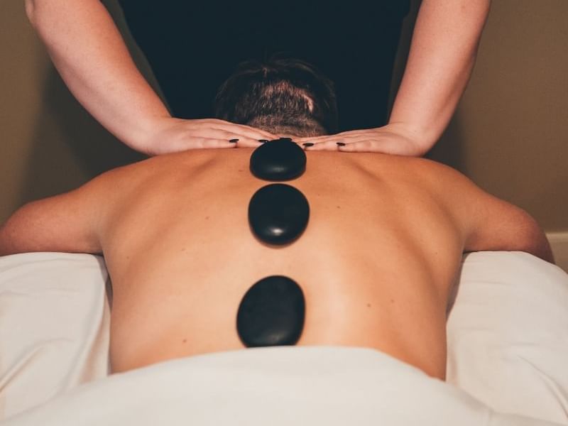 Man having a hot stone massage in Sun Tree Spa at Temple Gardens Hotel & Spa