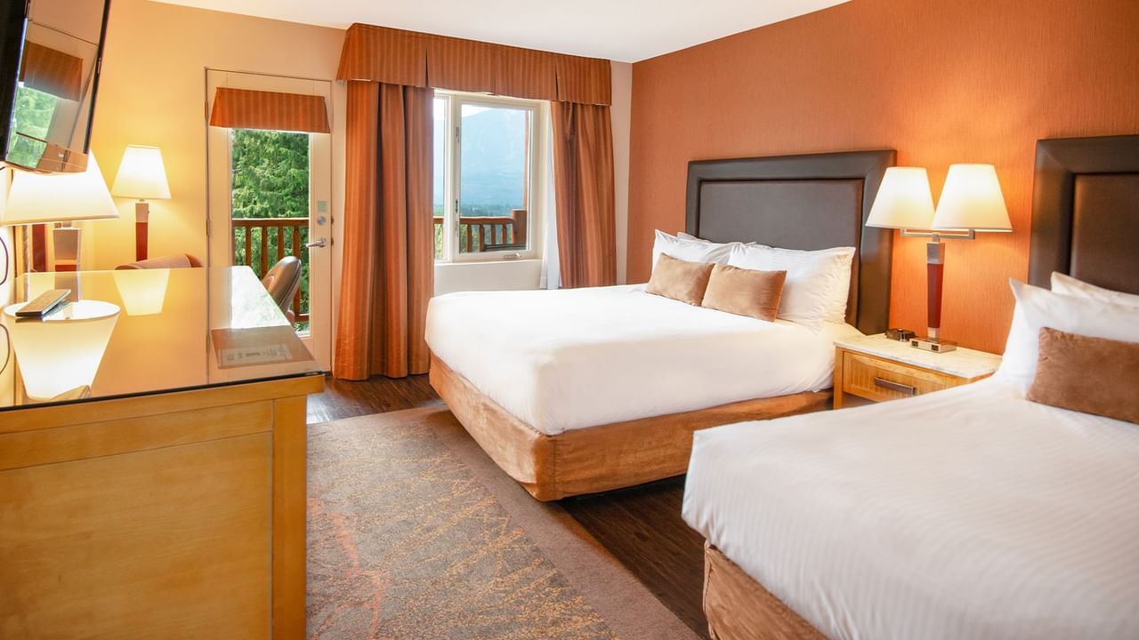 Hotel guest room with two queen beds and a balcony