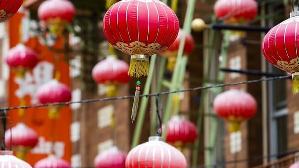 Red paper lanterns hanging under a street canopy near Warwick San Francisco