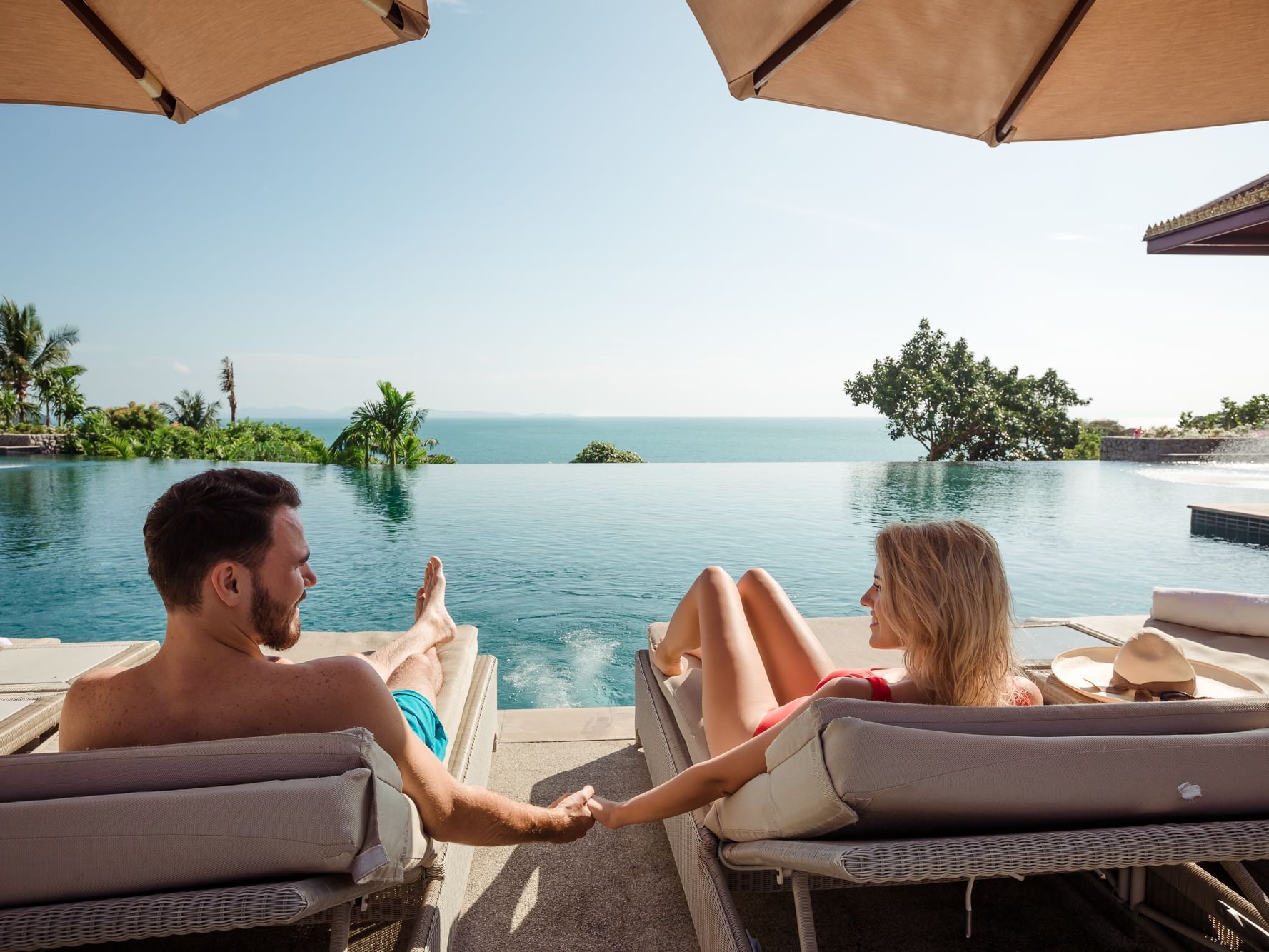 A couple relaxing on a sunbed at Amatara Wellness Resort