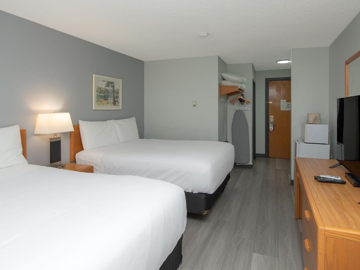 Coast Two Queens Pet Friendly room with two queen beds, gray wood floors and modern furnishings.