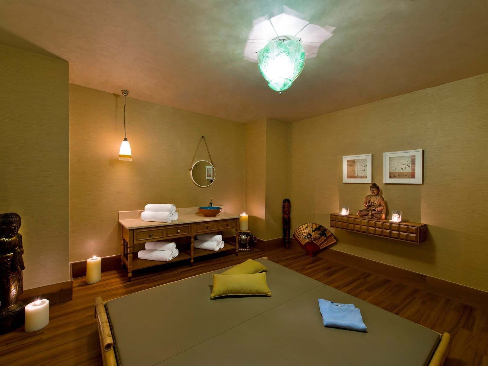 Comfy massage beds around lit up with candles in BeFine Spa at Titanic Deluxe Lara