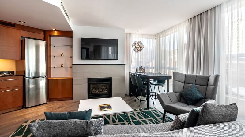 Sofa facing the TV and fireplace in Penthouse Suite Sainte-Catherine at Warwick Le Crystal