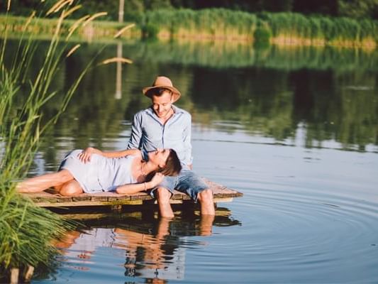 A romantic couple on a deck in a lake near Originals Hotels