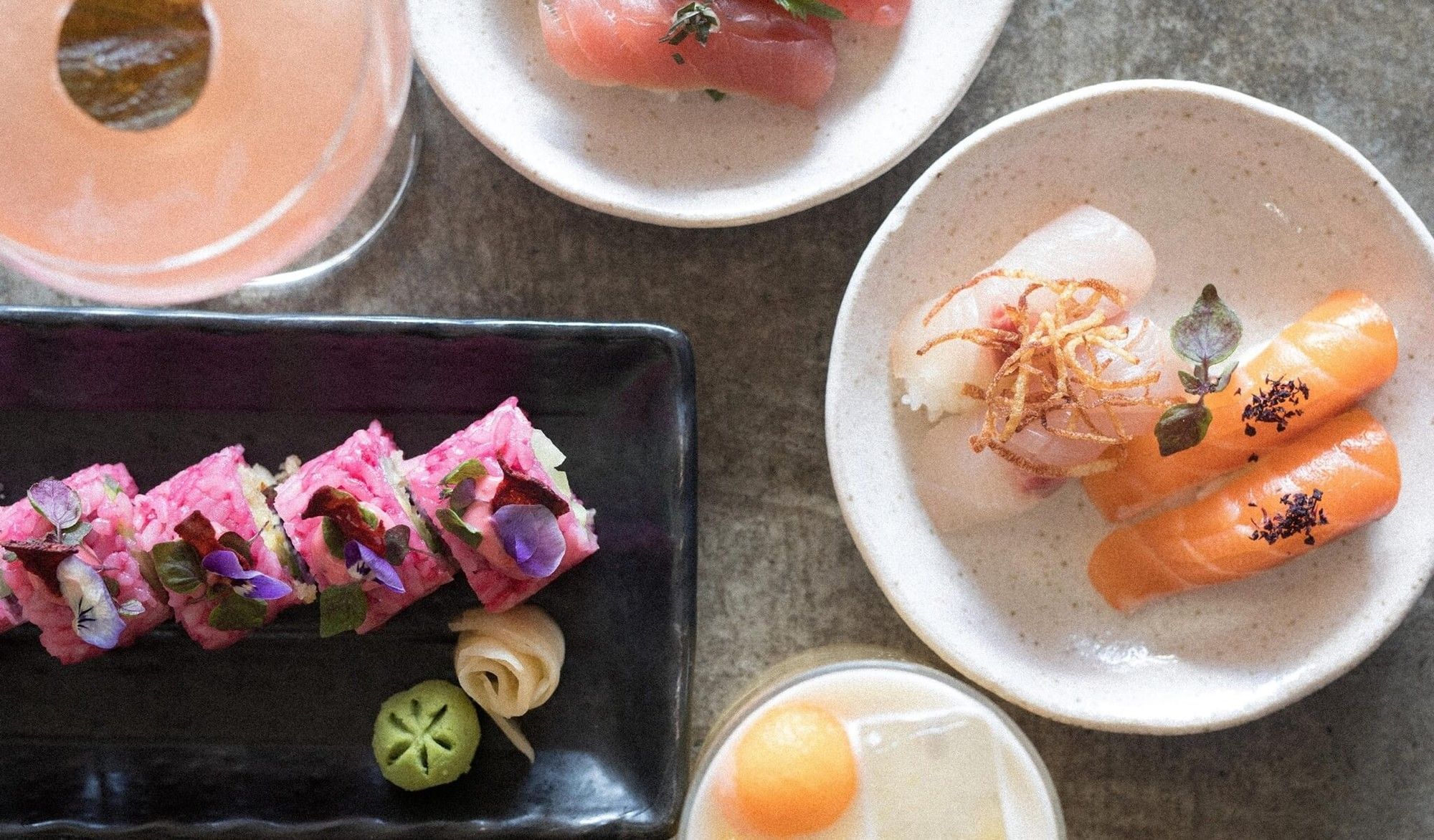 Cibaria Manly Hotel at Elysium Hotels features colourful sushi rolls and sashimi on ceramic plates on concrete