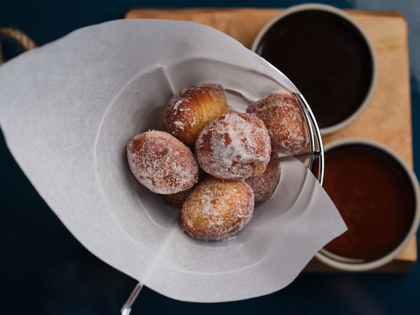 Close-up of powdered sugar Donuts in the Restaurant at The Capital Hotel London
