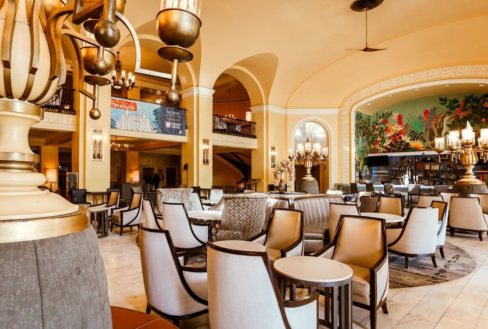 Modern seating by a colorful mural under tall arches in the central lobby at Arlington Resort Hotel & Spa