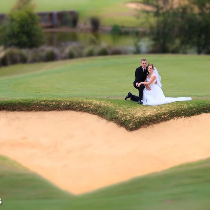 Wedded couple posing for photos outside of Mercure Kooindah Waters