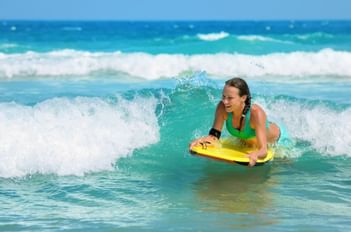 Close-up on a girl surfing near Southern Palms Beach Club