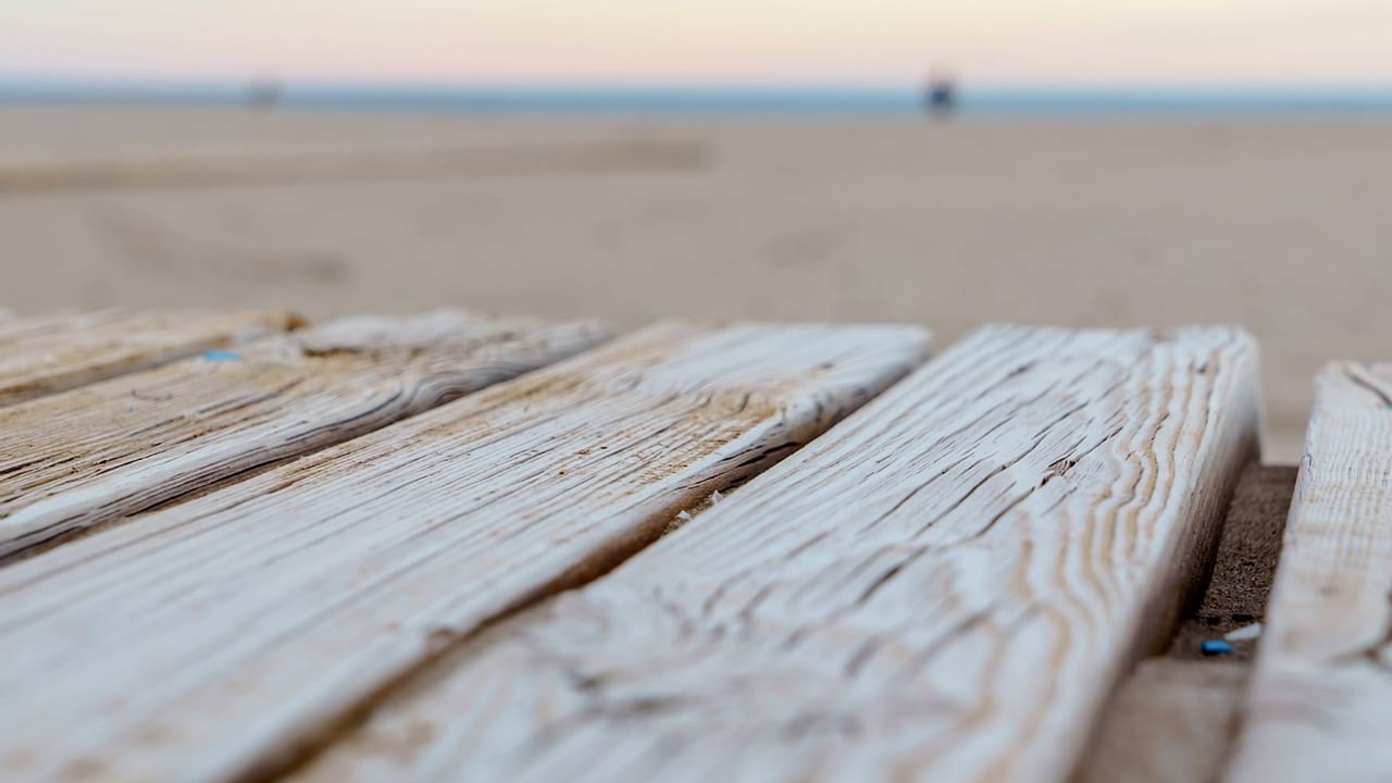 wooden walkway with beach in the background
