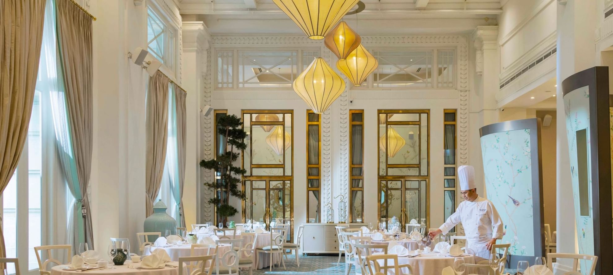Dining table arrangements in Jade with carpeted floors at The Fullerton Hotel Singapore