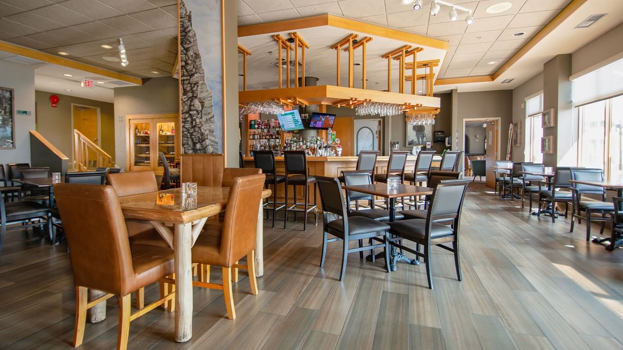 Hotel restaurant with dining table, chair, and bar