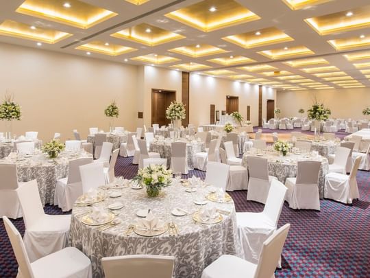 Elegantly decorated event room with round tables and chairs at Camino Real Pedregal Mexico in Ciudad de Mexico