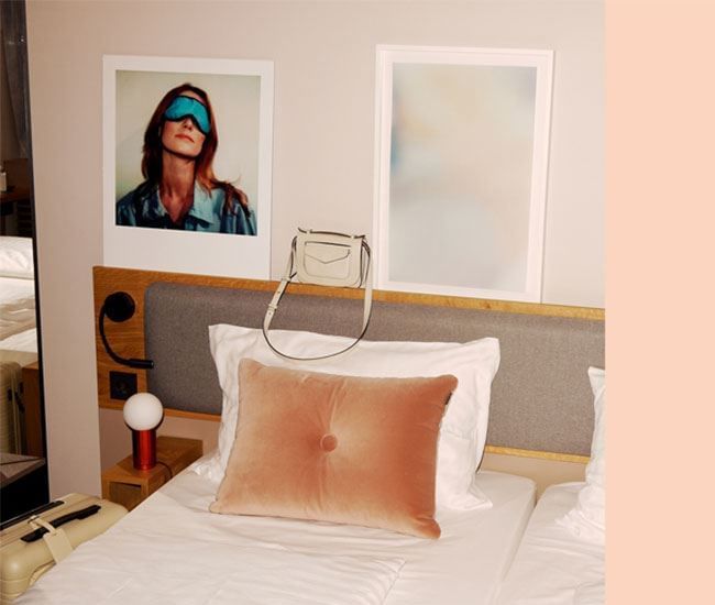 Handbag on the top of the bed at Flemings Hotels