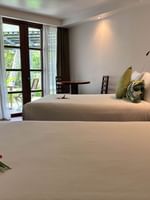 Two garden view double beds with floral arrangements at Warwick Fiji in Korolevu.