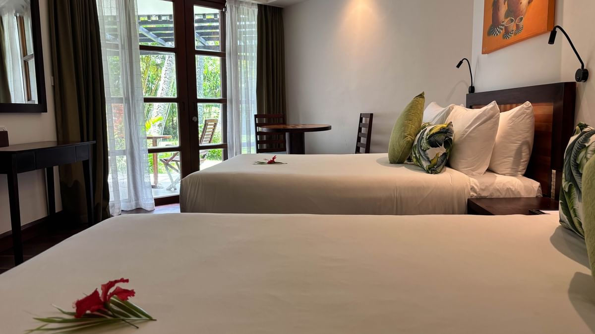 Two cozy beds with garden view at Warwick Fiji Resort and Spa in Korolevu.