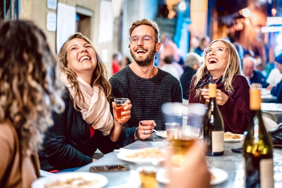 Group of friends enjoying wine outdoors at Blackcomb Springs Suites