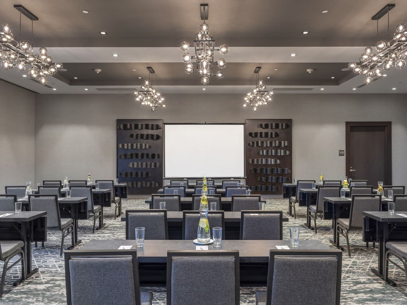 tables and chairs facing a projector screen