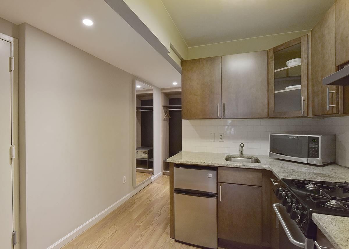 A kitchen with modern appliances and granite countertops.